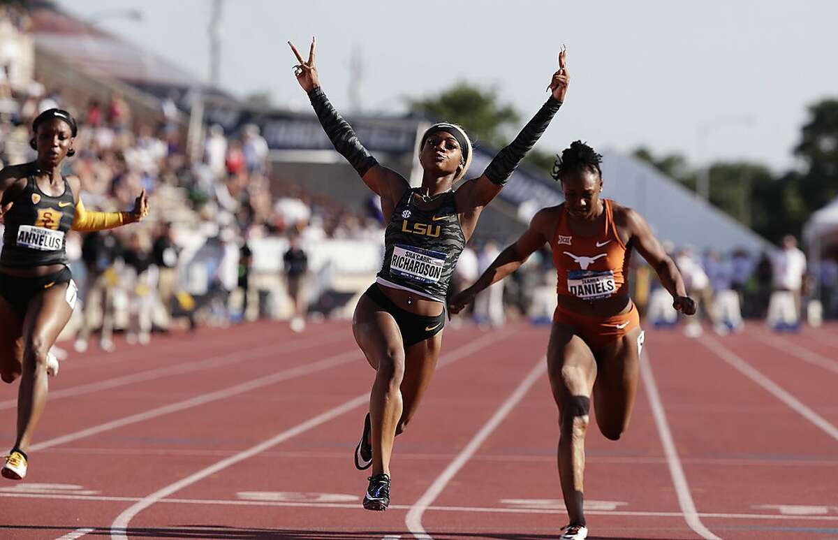 LSU's Sha'Carri Richardson, center, celebrates as she wins the women's 100 meters during the NCAA outdoor track and field championships in Austin, Texas, Saturday, June 8, 2019. (AP Photo/Eric Gay)