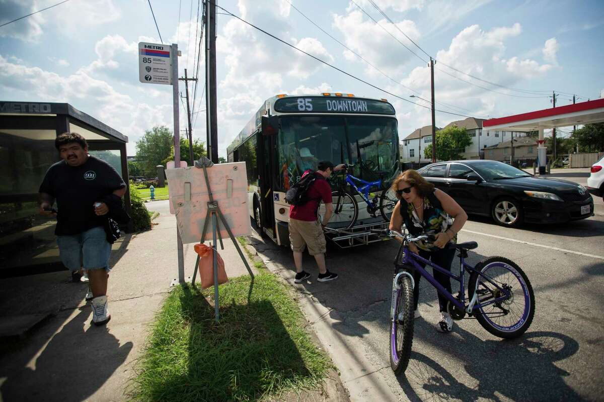 Commuters leave a Metro Route 85 bus at Washington and Studemont on June 11.