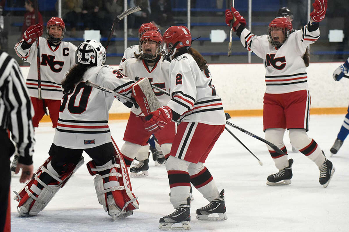 The New Canaan Rams begin their celebration after winning the CHSGHA state championship with a 3-1 victory over Darien in the final at Bennett Rink in West Haven on Saturday, March 9. — Dave Stewart/Hearst Connecticut Media