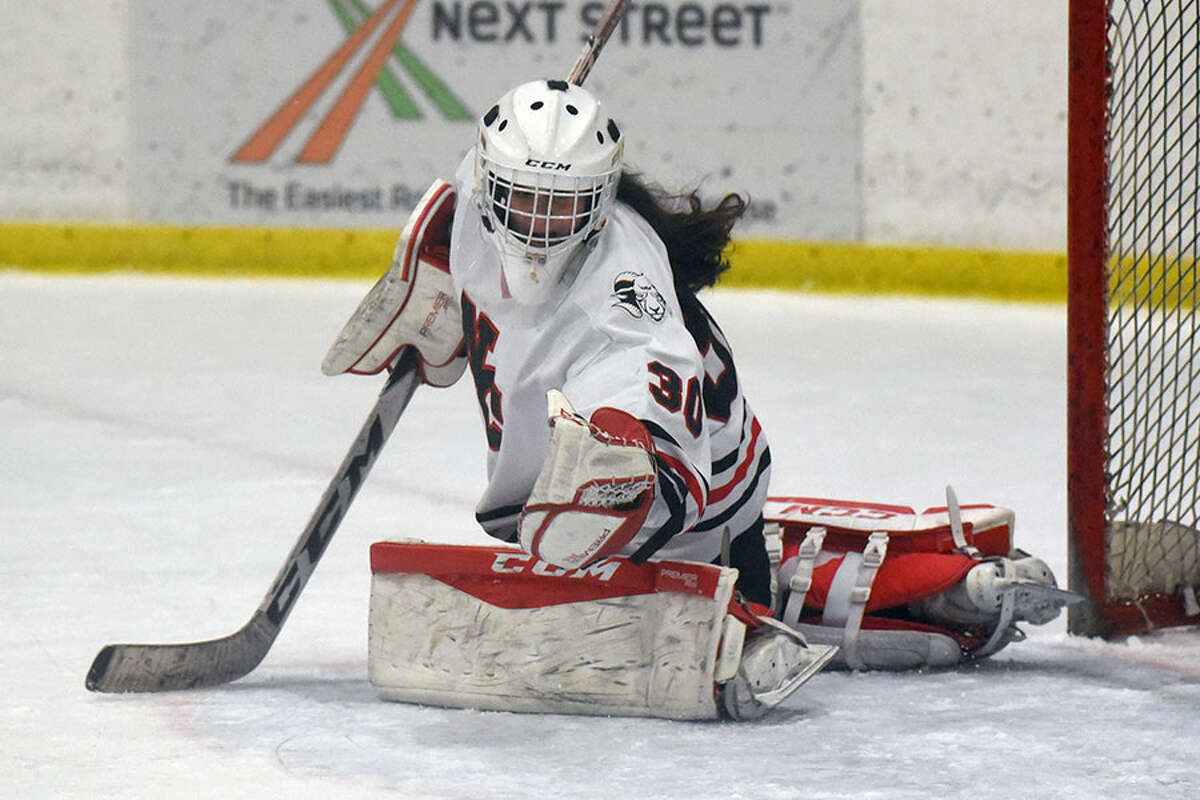 New Canaan goalie Blythe Novick makes a glove save during the CHSGHA State semifinals at The Rinks at Shelton on Wednesday, March 6. — Dave Stewart/Hearst Connecticut Media