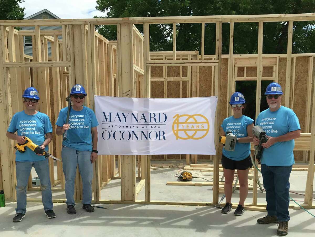 The law firm of Maynard, O'Connor, Smith & Catalinotto is celebrating its 100th anniversary through a series of events, including volunteering to give back to the community. On June 15, several members of the firm worked with Habitat for Humanity Capital District to help frame a new home in South Troy. (Photo provided)