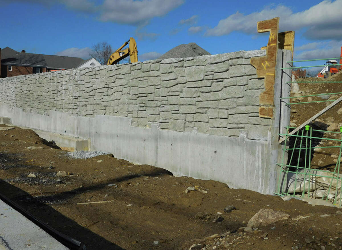 A view of a concrete wall built along Park Street as part of the Merritt Village residential project being constructed.