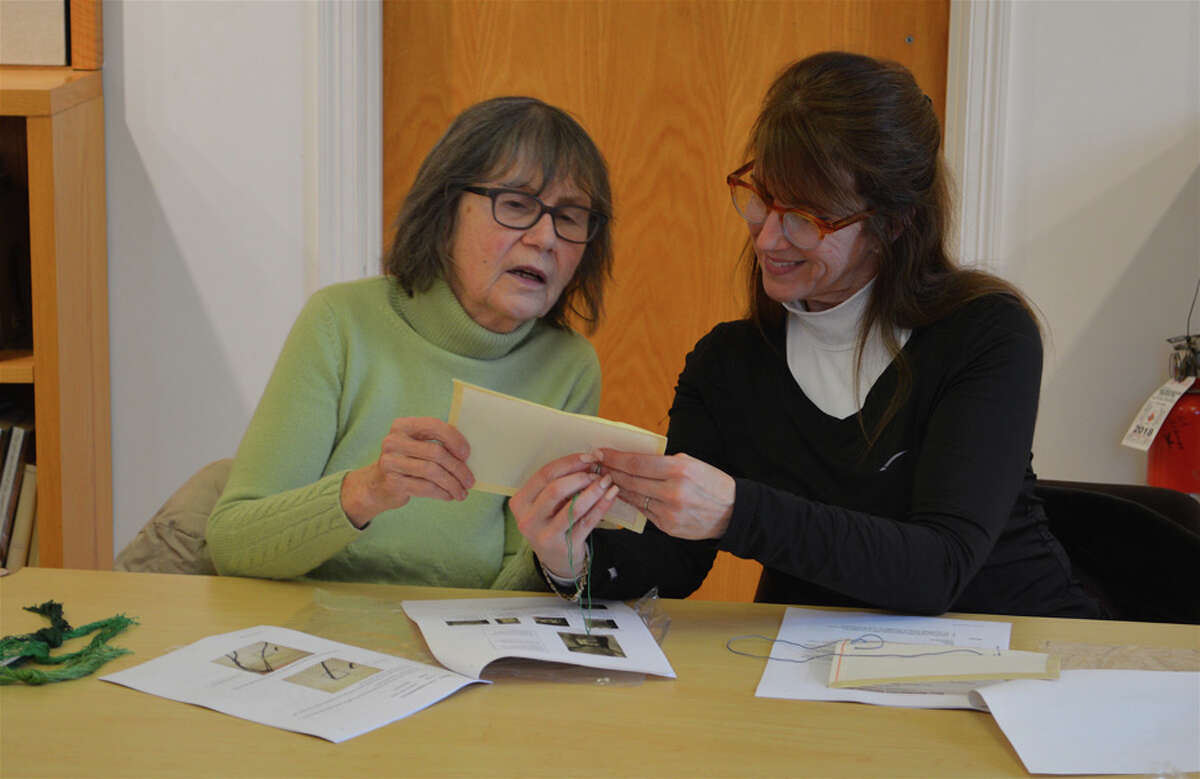 Mary Ward, left, and Christie Hartnett, both of New Canaan, review their work together at the introductory needlepoint class at New Canaan Library on Sunday, Feb. 24, 2019. Jarret Liotta Hearst Connecticut Media