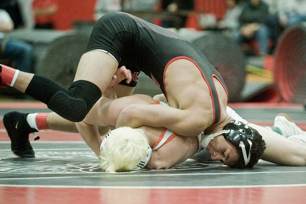 New Canaan High School's Tyler Sung wrestles Danbury's Ben LeBlanc in the 145-pound class during the FCIAC tournament finals Saturday at NCHS. — Scott Mullin photo