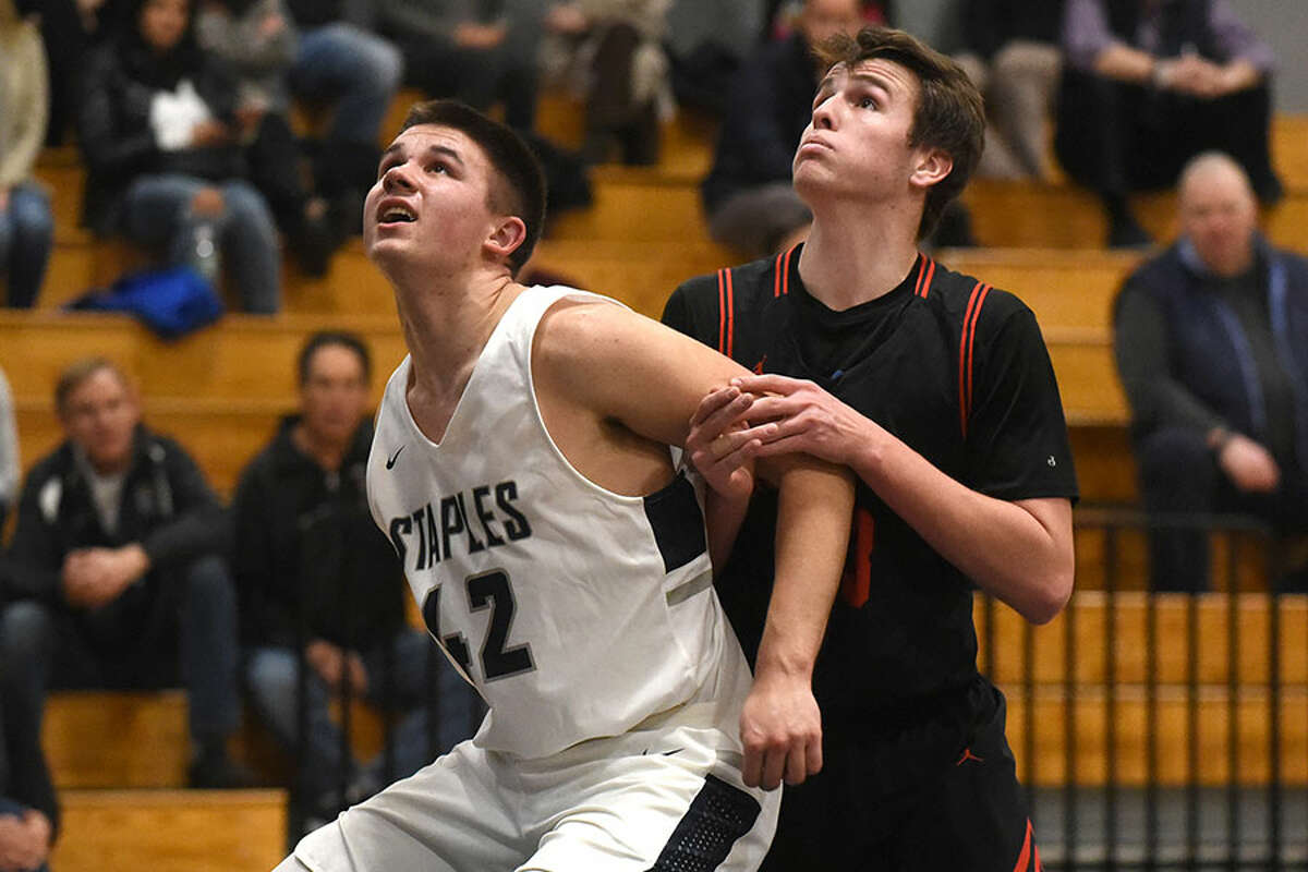 Staples' AJ Konstanty (42) and New Canaan's Jack Richardson battle for position on a free throw during a boys basketball game at Staples High School on Monday, Feb. 18. — Dave Stewart/Hearst Connecticut Media photo