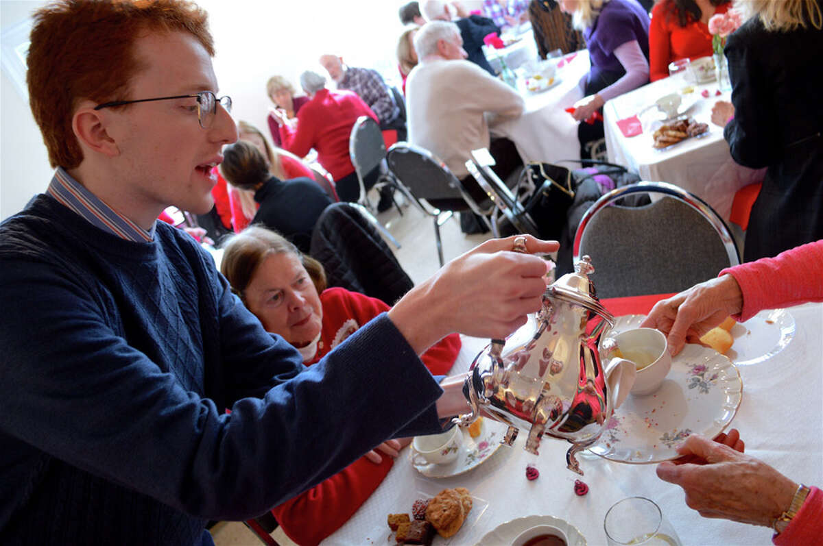 Mike Murphy, librarian archivist at the New Canaan Historical Society, deftly serves the tea at the annual Valentine's Day tea on Thursday, Feb. 14, 2019. Jarret Liotta / Hearst Connecticut Media
