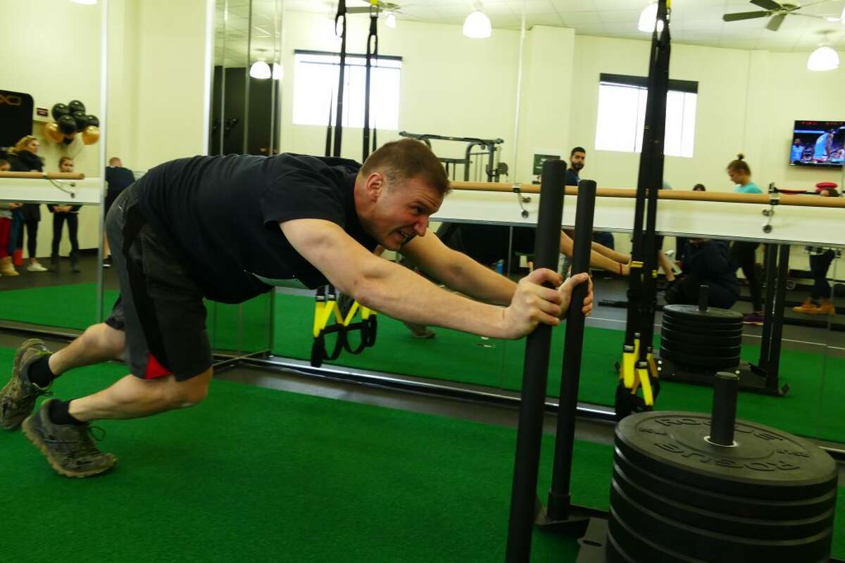 Firefighter Michael Jackson propels the 300-pound sled push forward. — Grace Duffield photo.