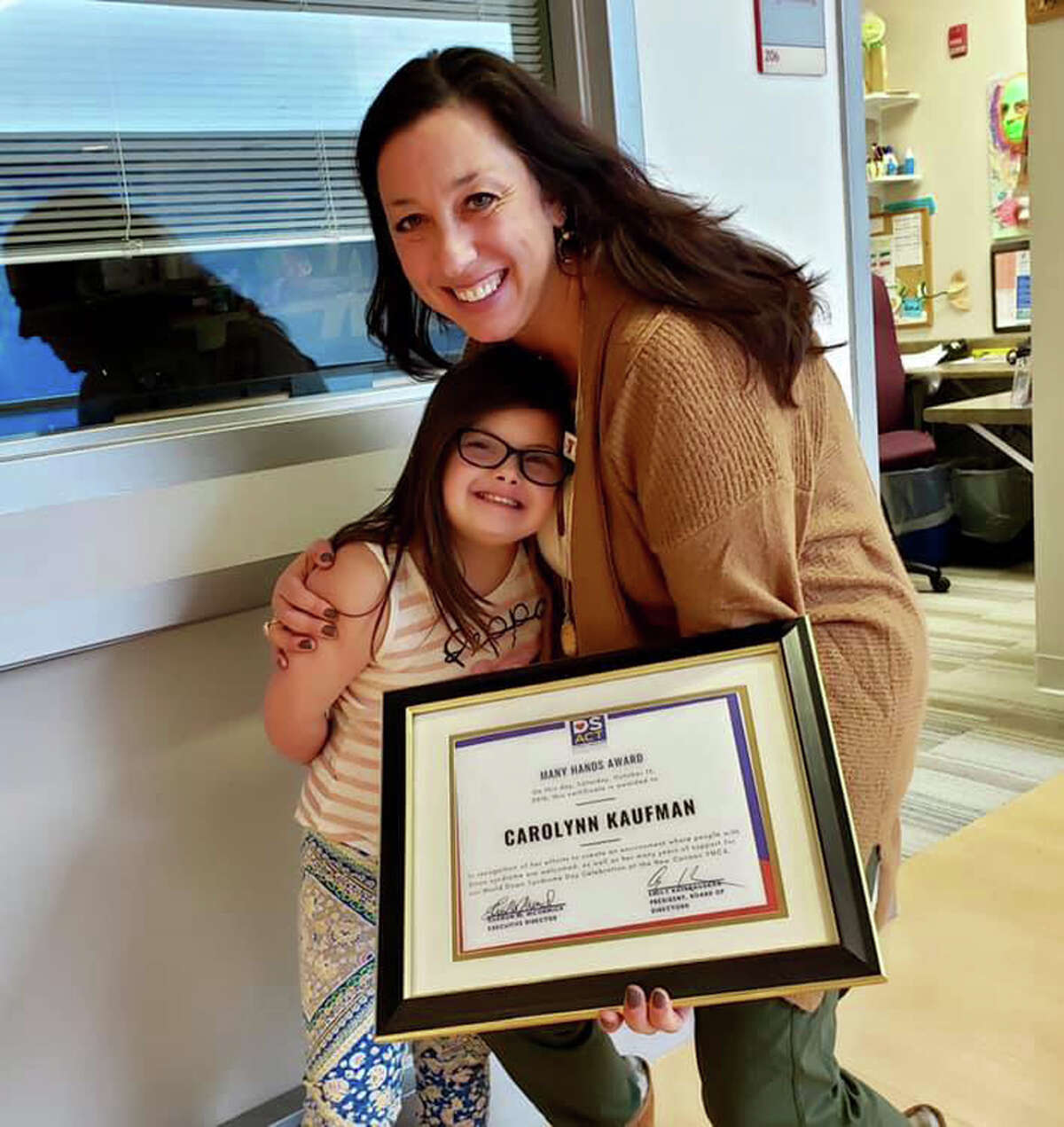 Carolynn Kaufman, New Canaan YMCA Director of Special Needs Programming, shown with Amber Lehrman at New Canaan YMCA on Dec. 8, received the Many Hands Award in the Constant Contributor category from the Down Syndrome Association of Connecticut.