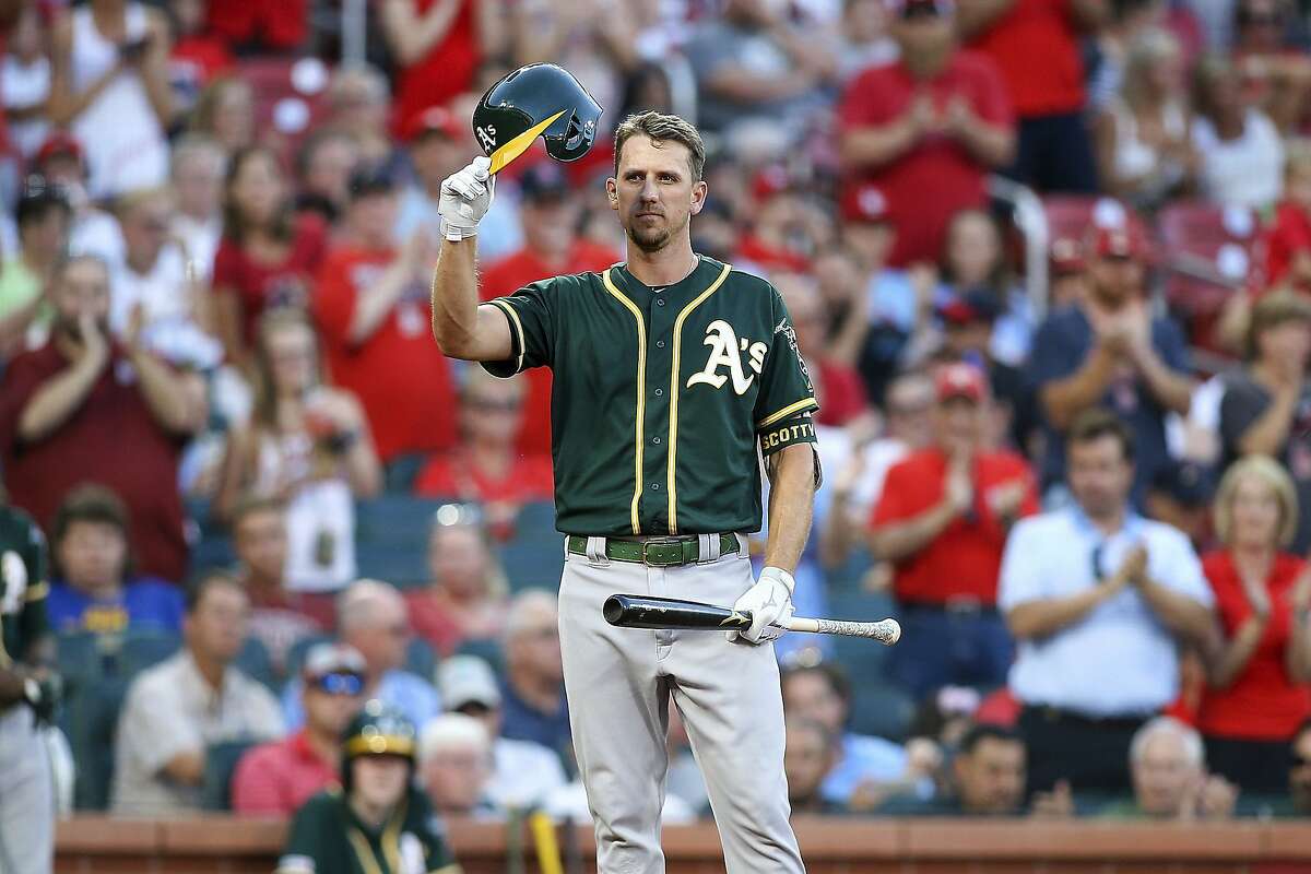 Former St. Louis Cardinals player Stephen Piscotty, now with the Oakland Athletics, salutes fans as he receives a standing ovation as he steps up to the plate to bat during the first inning of a baseball game Tuesday, June 25, 2019, in St. Louis. (AP Photo/Scott Kane)