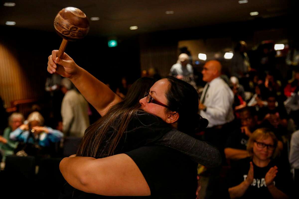 Mariposa de la Villaluna embraces Amy Anderson during the San Francisco Unified School District school board meeting where the board voted to remove or cover a controversial mural at George Washington High School Tuesday, June 25, 2019, in San Francisco, Calif.
