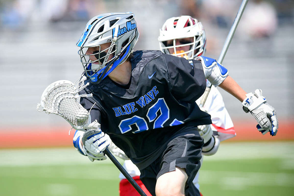 Darien's Jack Bogdan (32) drives up the field during a boys lacrosse game against Greenwich at Cardinal Stadium on Saturday. - Matthew Brown/Hearst Connecticut Media