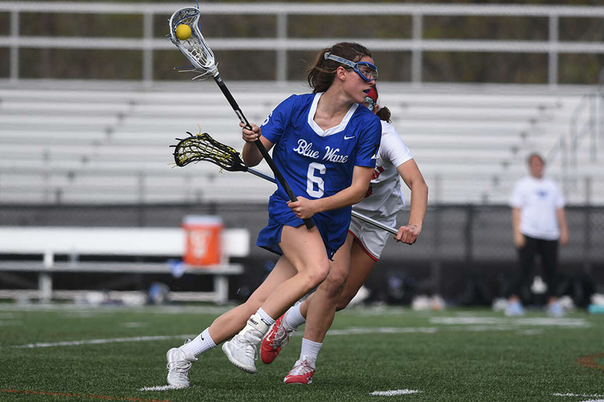 Darien senior co-captain Katie Elders makes a move to the net during the Wave's game at New Canaan on Saturday, May 4. — Dave Stewart/Hearst Connecticut Media