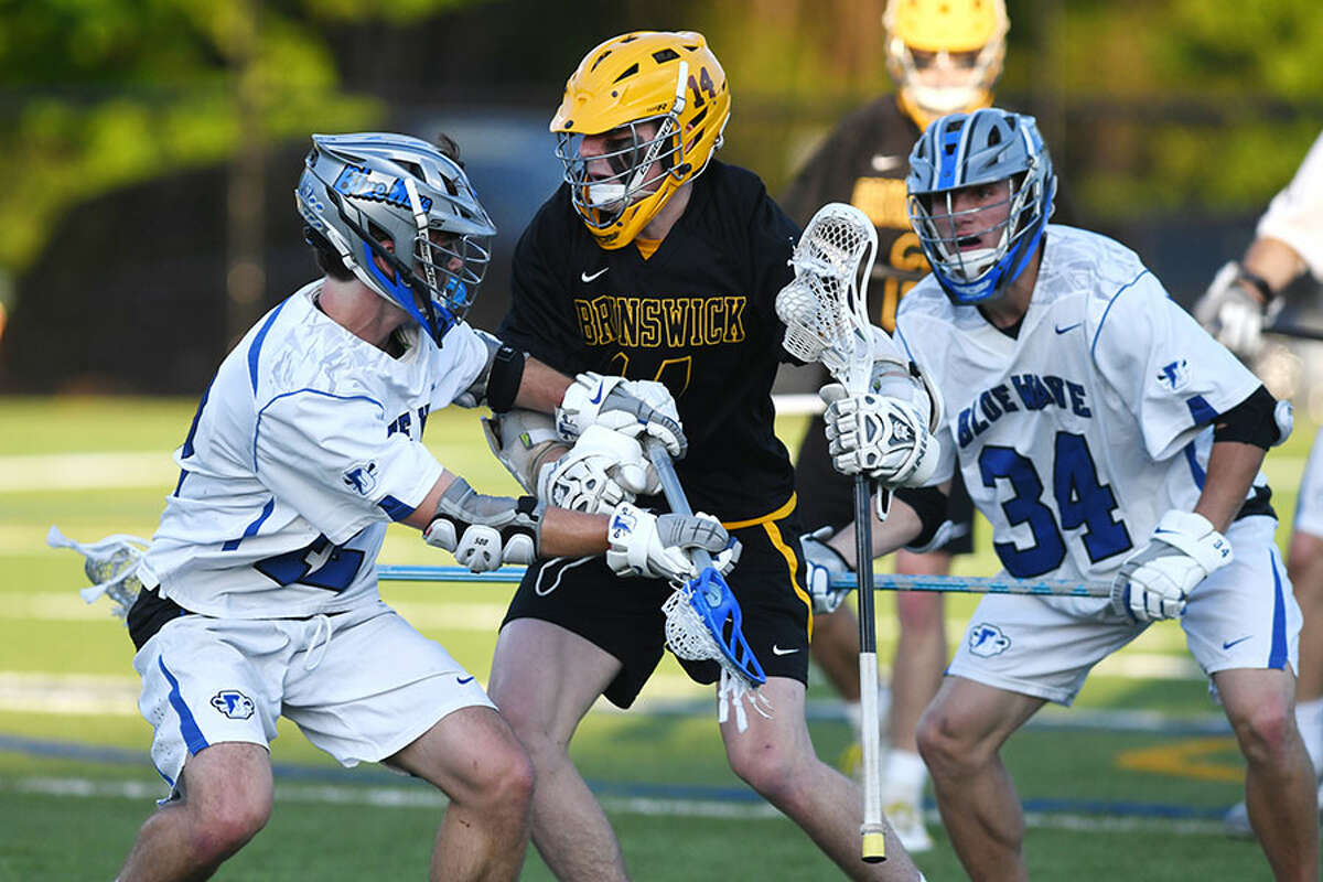The Darien defense attempts top slow down Brunswick's Cooper Moore during a boys lacrosse game on Wednesday in Greenwich. - Tyler Sizemore/Hearst Connecticut Media