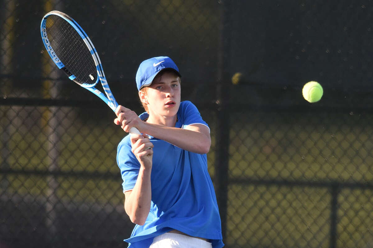 Darien's Nick Derby sends a backhand shot back over the net during the No. 3 singles match in the Wave's FCIAC semifinal contest at New Canaan on Thursday. - Dave Stewart/Hearst Connecticut Media