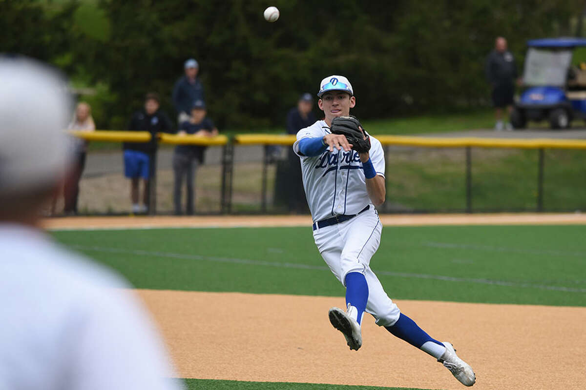 Darien shortstop Henry Williams (11) fires the ball to first base during the Blue Wave's baseball game against Staples at Darien High School on Monday, May 6, 2019. - Dave Stewart/Hearst Connecticut Media