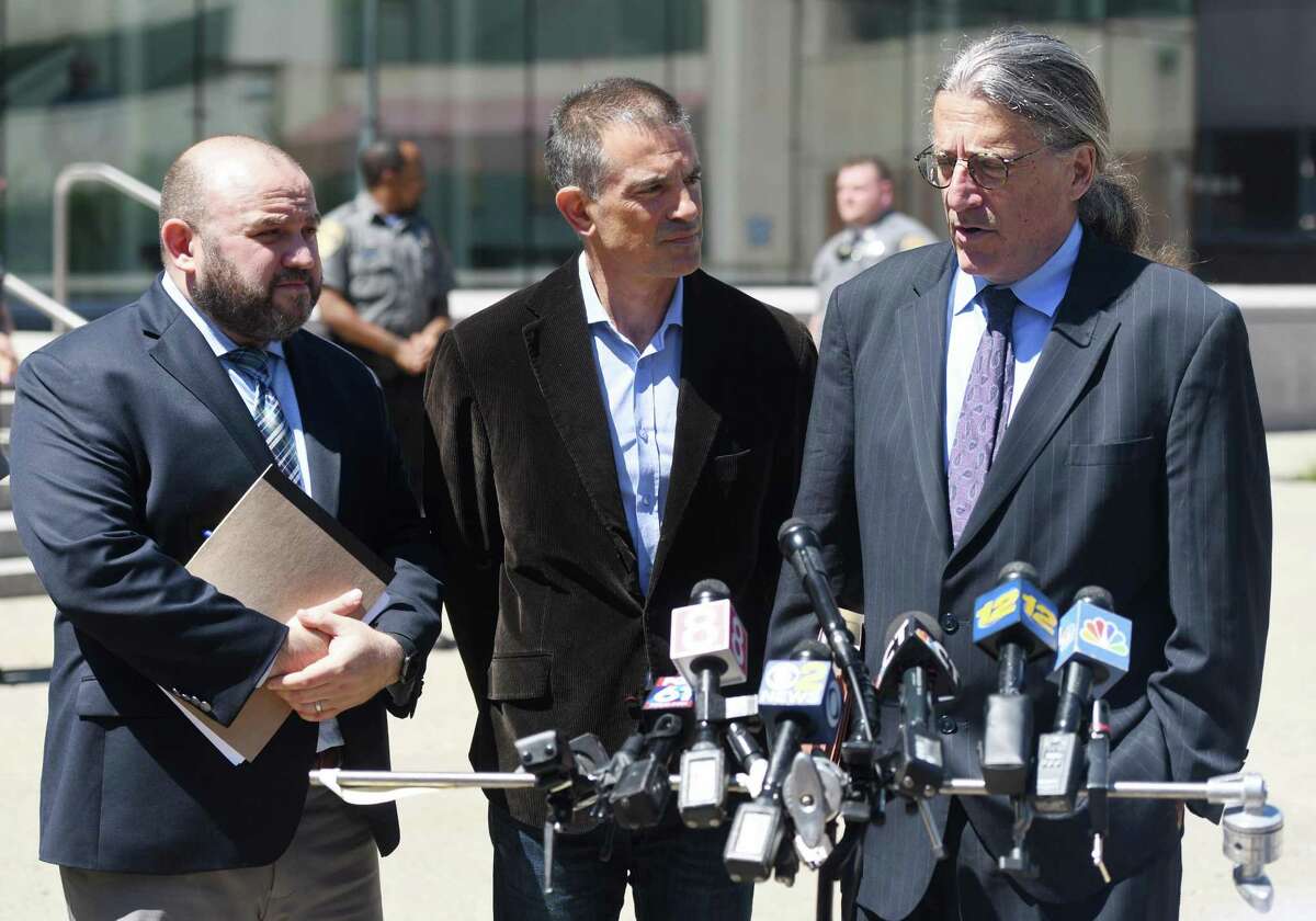 Fotis Dulos, center, is accompanied by his attorneys Rich Rochlin, left, and Norm Pattis after making an appearance at Connecticut Superior Court in Stamford, Conn. Wednesday, June 26, 2019.