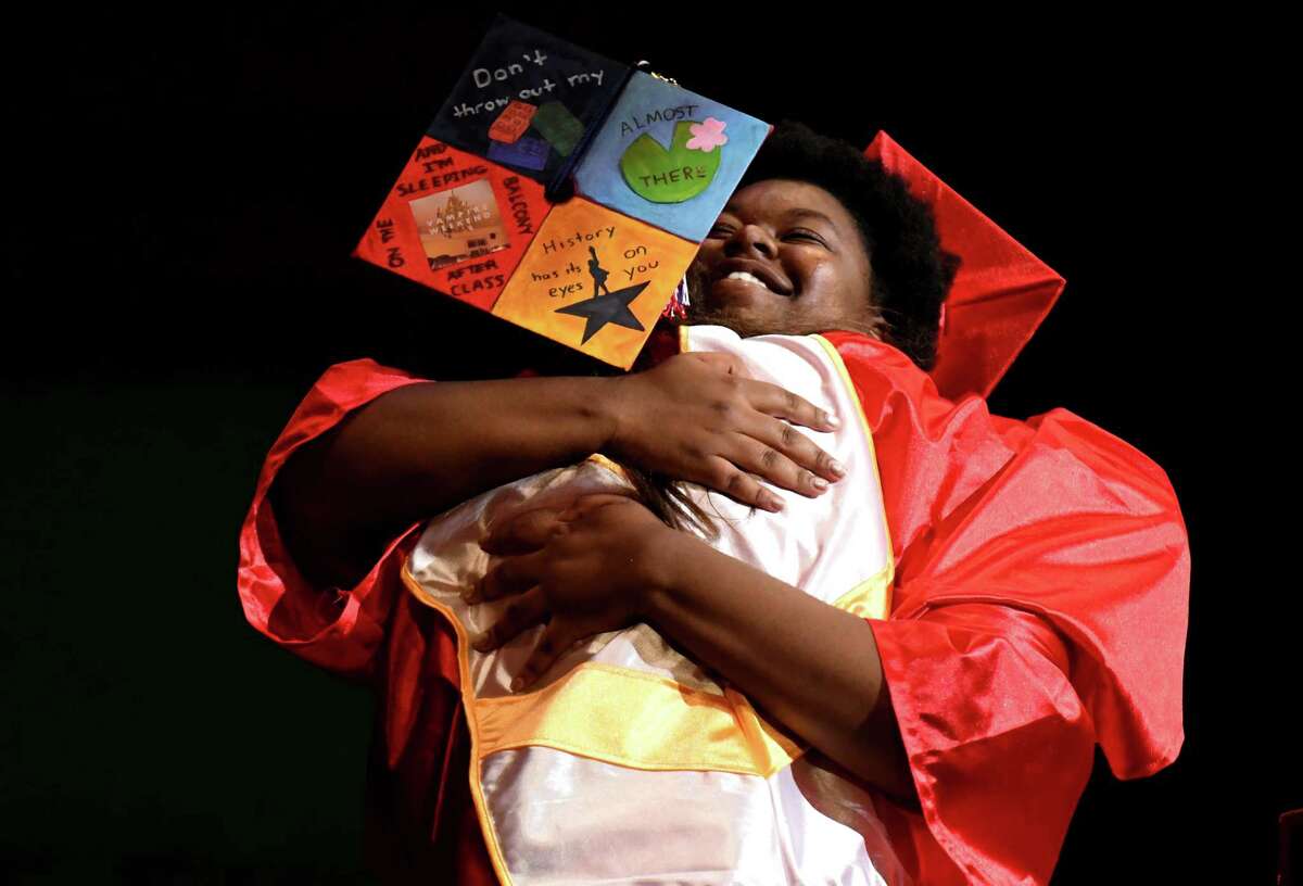 Schenectady High School valedictorian Anna Blanchfield, left, hugs class of 2019 president Natasha Wright, right, during the 27th commencement ceremony of Schenectady High School on Wednesday, June 26, 2019, at Proctors Theatre in Schenectady, N.Y. (Catherine Rafferty/Times Union)