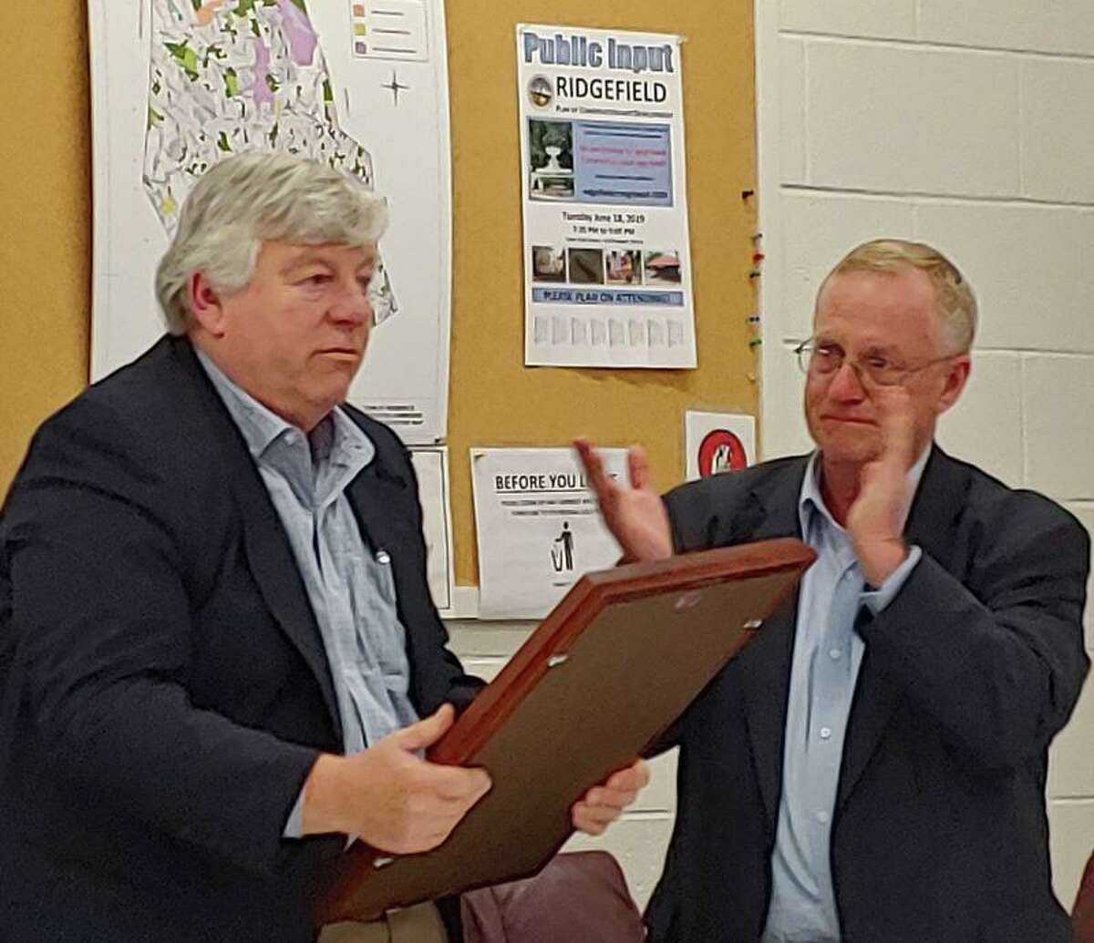 Lifelong Ridgefielder Charlie Knoche, left, received a plaque from the Police Commission Chairman George Kain in recognition for his 24 years of service on the commission. He stepped down June 13.