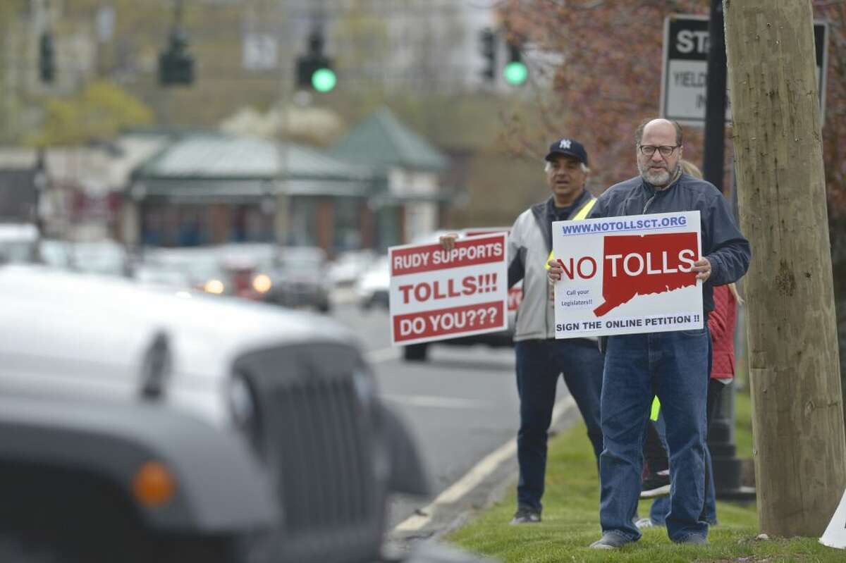 Rich Shapiro, of Southbury, right, and Joe Savino, of Ridgefield, take part in a No Tolls Ct protest at the corner of Copps Hill Road and Danbury Road on Saturday morning, April 27, 2019, in Ridgefield, Conn.