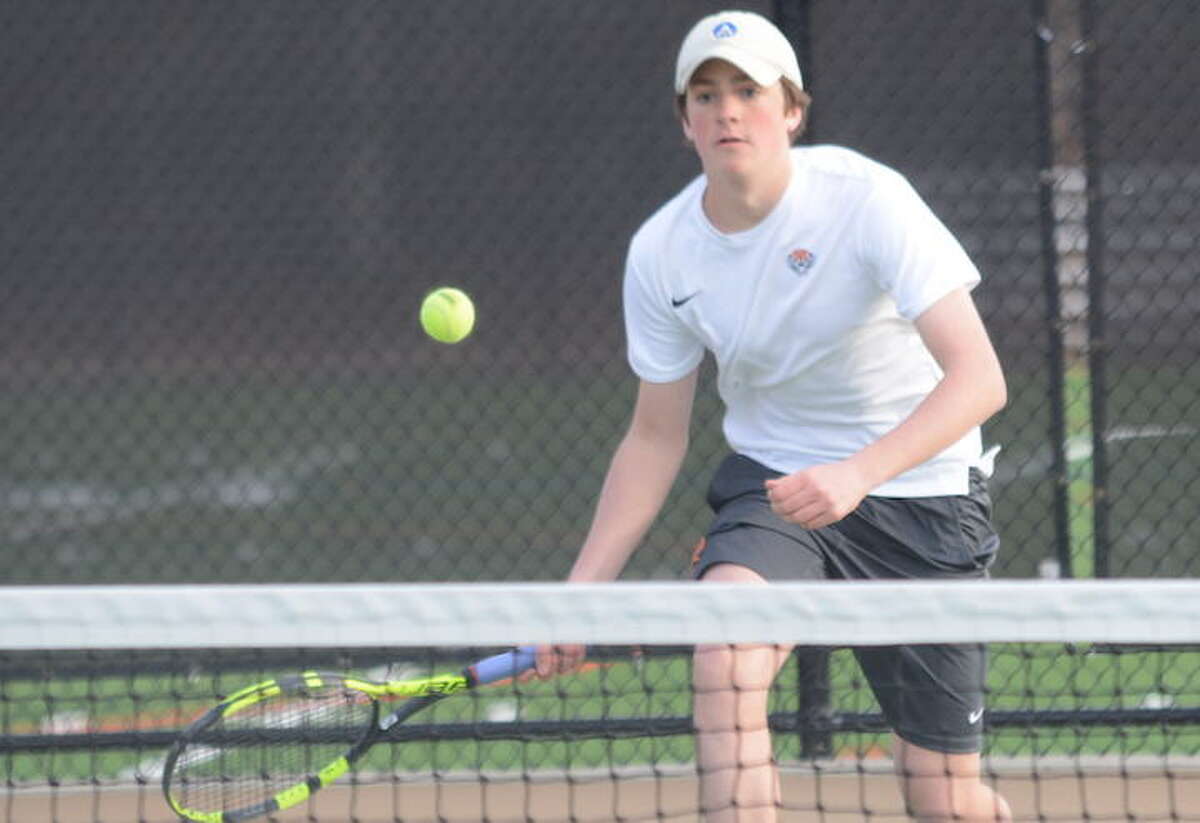 Carter Schroppe lines up a return shot during a recent Ridgefield High boys tennis match. - Andy Hutchison photo