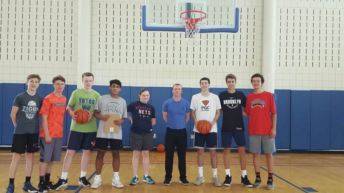 Local basketball referee Josh Davis, sixth from the left, made 37 of 50 free throw shots and helped raise $8,000 for the Trailblazers Academy basketball program last year. The initiative was sponsored by RHS's Full Court Peace Club and returns to Yanity gym this weekend. In 2018, more than $10,000 was raised by shooting free throws. Also pictured, from left: Shane Gagliardi, Jason Hartnett, Derek Szpakowski, Yohann Britto (club president), Maya Peck, James Rush, Emmett O'Malley, Quentin Vergara. For more information on Full Court Peace, visit fullcourtpeace.org.