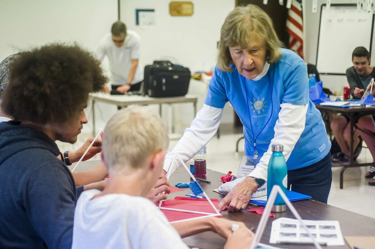 Dot Hornsby assists participants of the Midland Barstow Aviation Camp in building tetrahedron kites on Wednesday, June 26, 2019 at Jack Barstow Municipal Airport. (Katy Kildee/kkildee@mdn.net)
