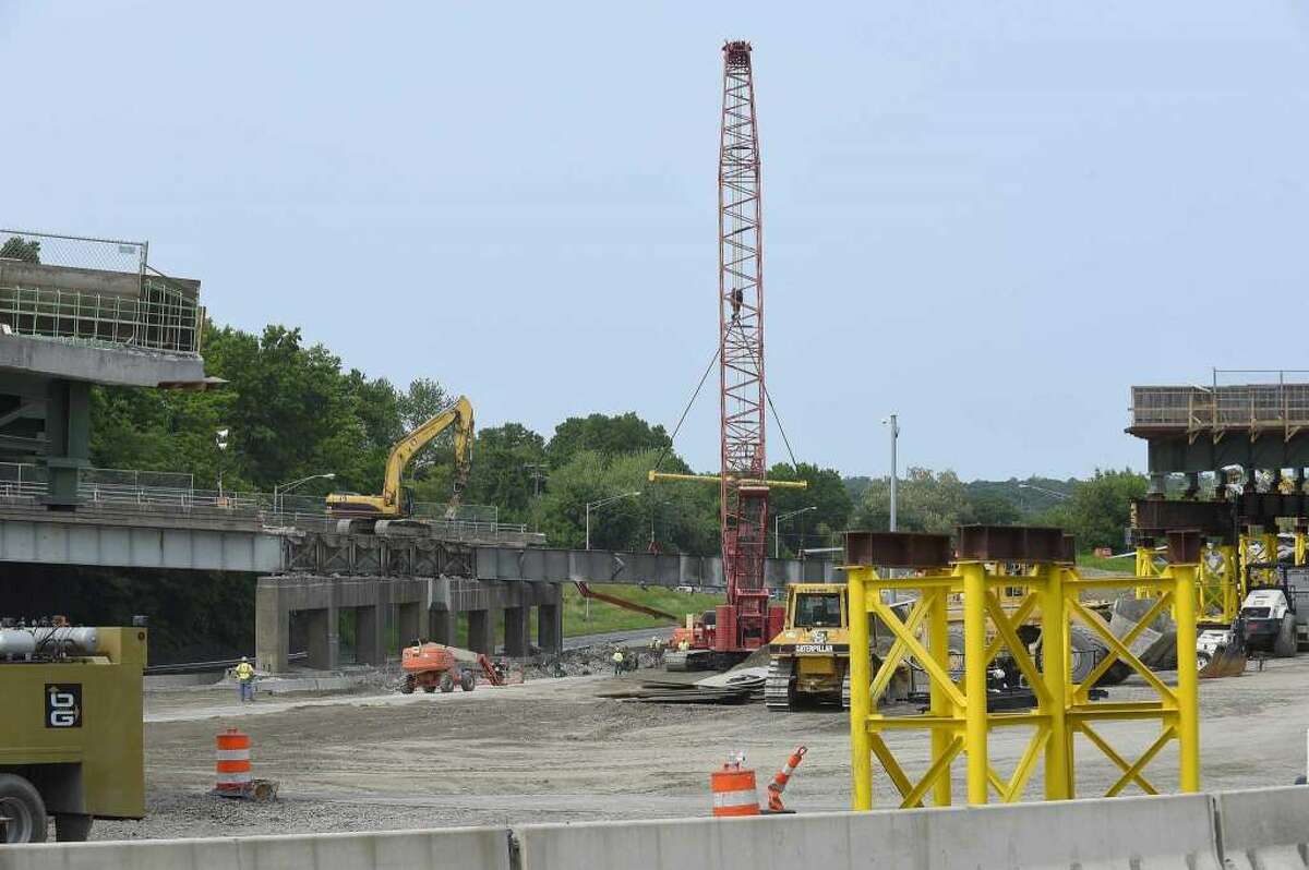 Work crews work to remove a dilapidated Route 1 bridge on June 1, 2019 that spans I-95 at exit 9 in Stamford, Conn., making way for new spans of prefabricated bridge. —Matthew Brown / Hearst Connecticut Media