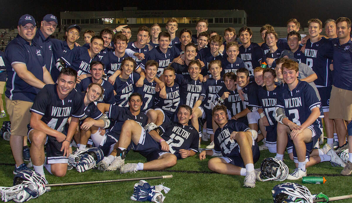 The Wilton High boys lacrosse team celebrates its 7-6 win over Fairfield Prep in the Class L semifinals. — GretchenMcMahonPhotography.com
