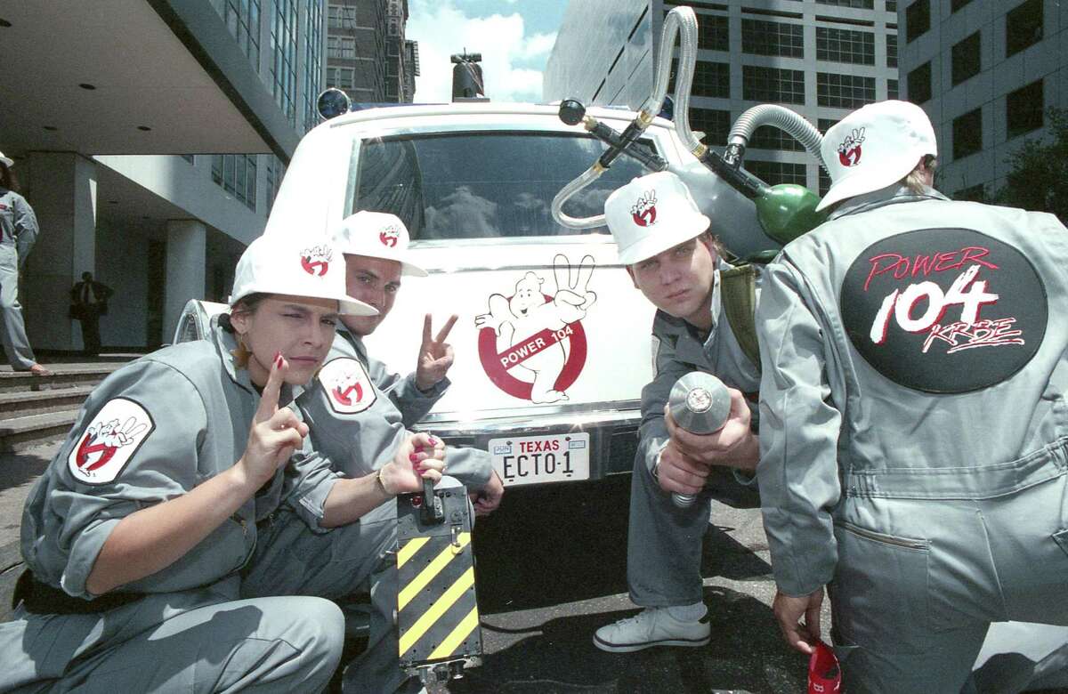 KRBE DJs, including Glenn Beck, center, dressed as the Ghostbusters as part of a promotion to give away an Ecto-1 similar to the vehicle used in the "Ghostbusters" film. Here, the vehicle is parked outside the Houston Chronicle building at 801 Texas on June 8, 1989. The promotion is in advance of the release of "Ghostbusters II."
