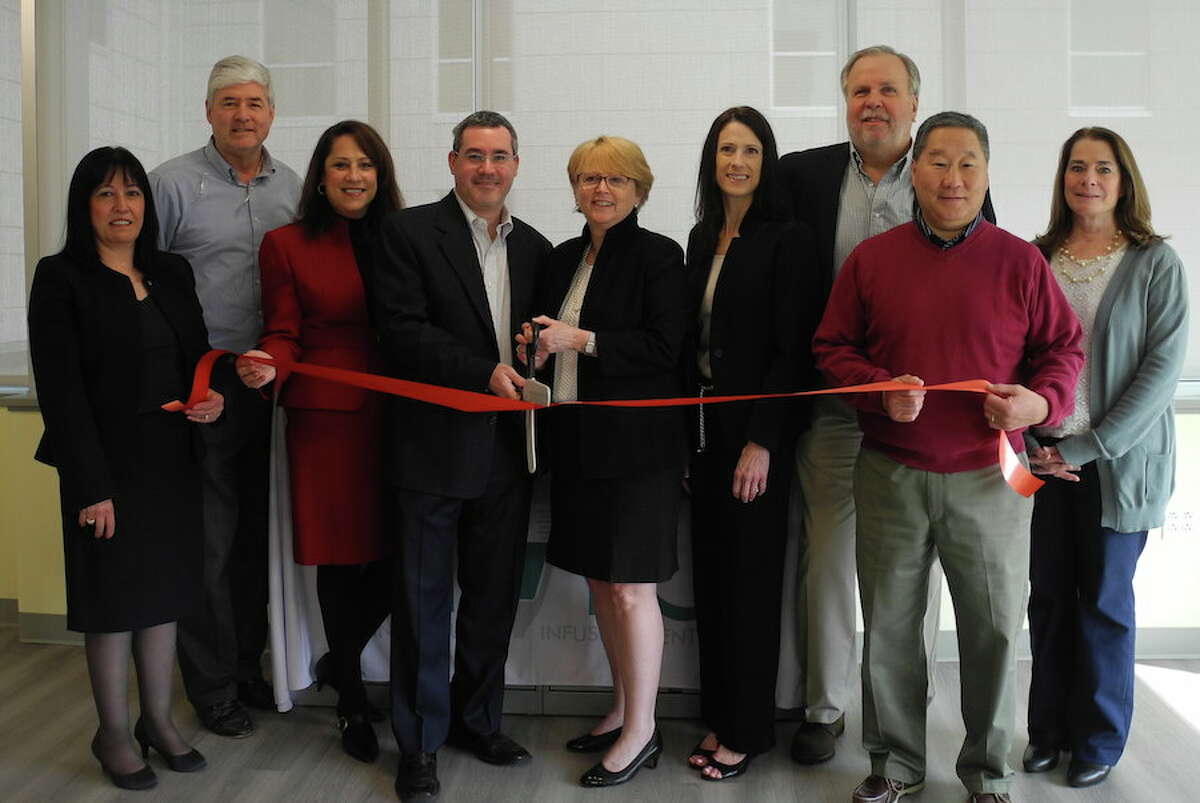 At the ribbon-cutting ceremony for the Connecticut Infusion Center on May 9 are, from left, Bankwell Vice President Vittoria Maccaro; Chamber of Commerce member Brian Perry; Debby Rowland, executive director of the infusion center; infusion center co-owner Dr. Barry Stein, First Selectwoman Lynne Vanderslice; Lisa Fusco, infusion center territory sales manager, and Pat Russo, Tom Sato and Susan Goldman of the Wilton Chamber of Commerce. Missing from photo is co-owner Dr. Robert Roteman. — Jeannette Ross/Hearst Connecticut Media