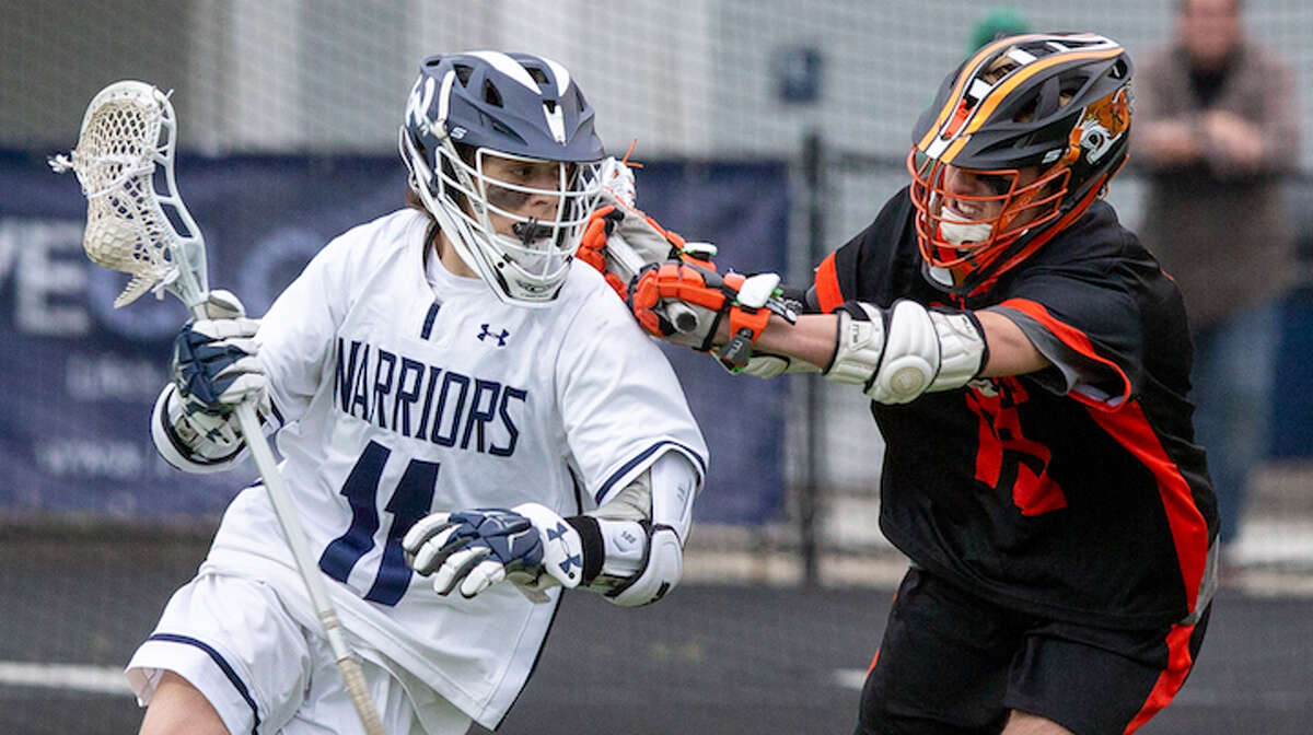Liam McGovern tries to get around a Ridgefield player during Thursday night's game. — GretchenMcMahonPhotography.com