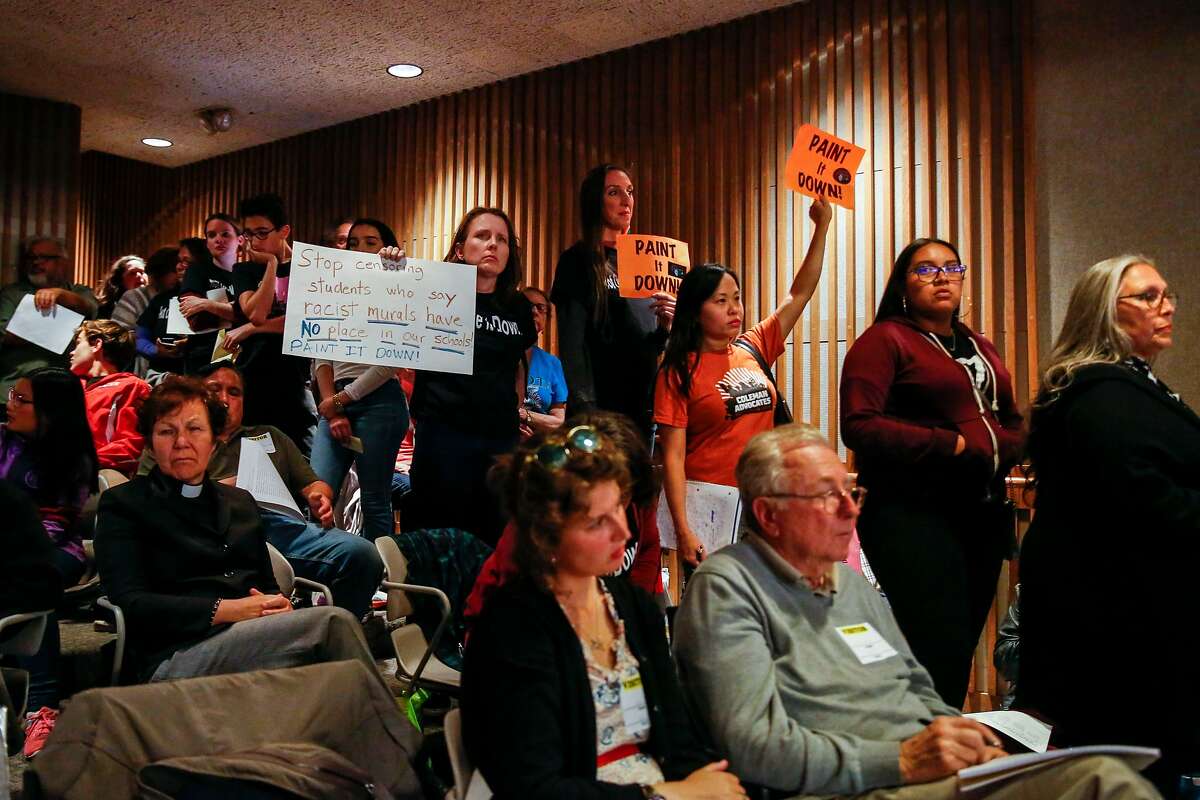 Supporters of covering up or removing the controversial mural at George Washington High School wait to speak during the San Francisco Unified School District board meeting where the board decided to remove or cover up the mural Tuesday, June 25, 2019, in San Francisco, Calif.