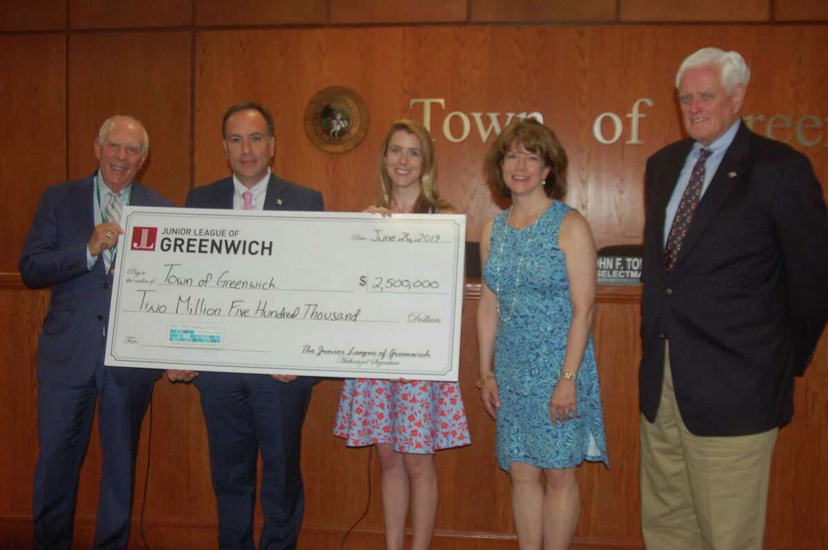 The Junior League of Greenwich presents the final dollars needed to complete its $2.5 million pledge for a public/private partnership with the town to build the town’s new municipal pool on Wednesday, June 26, 2019, at Greenwich Town Hall. The pool was opened last year to great success and the league has delivered on its pledge on schedule. From left, Selectman Sandy Litvack, First Selectman Peter Tesei, League President Elizabeth Peyton, President-Elect Hilary Watson and Selectman John Toner are all on hand for the presentation.