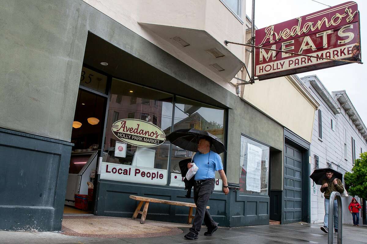 People walk past Avedano's Meats on Wednesday, May 15, 2019, in San Francisco, Calif.