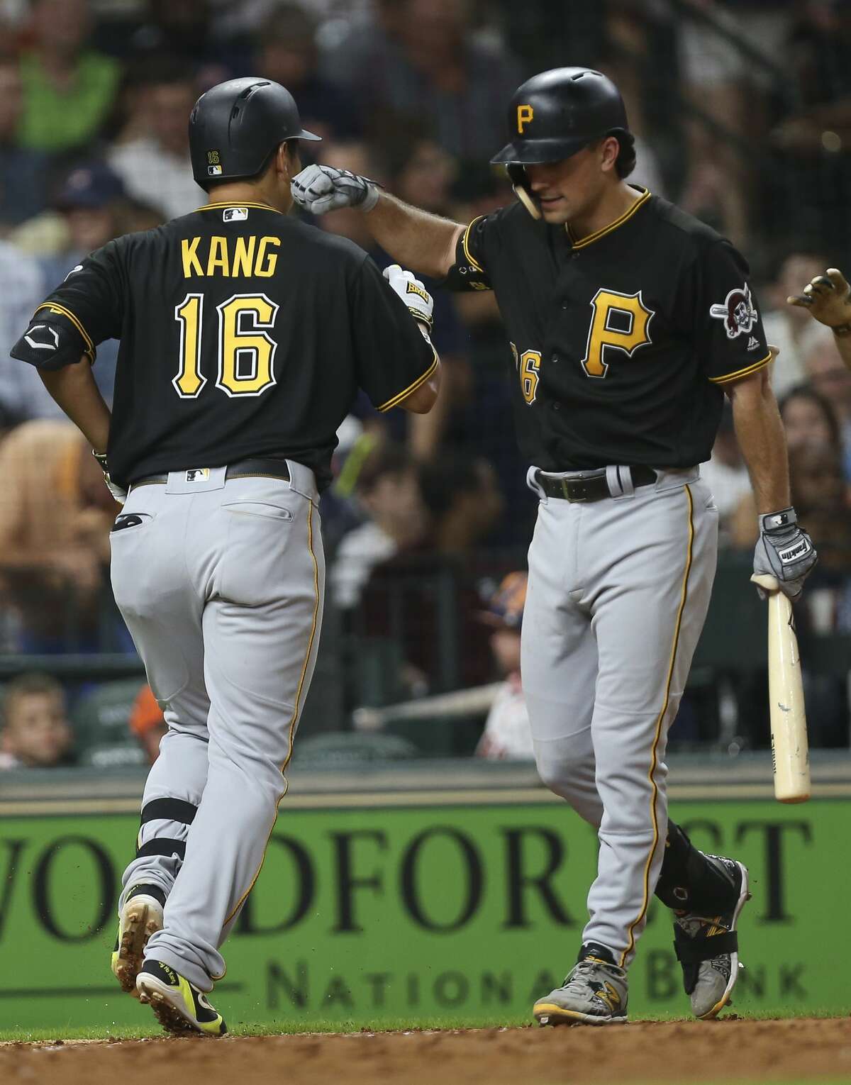 Pittsburgh Pirates third baseman Jung Ho Kang (16) is congratulated by Adam Frazier (26) after his two-run home run during the top sixth inning of the MLB game against the Houston Astros at Minute Maid Park on Wednesday, June 26, 2019, in Houston.