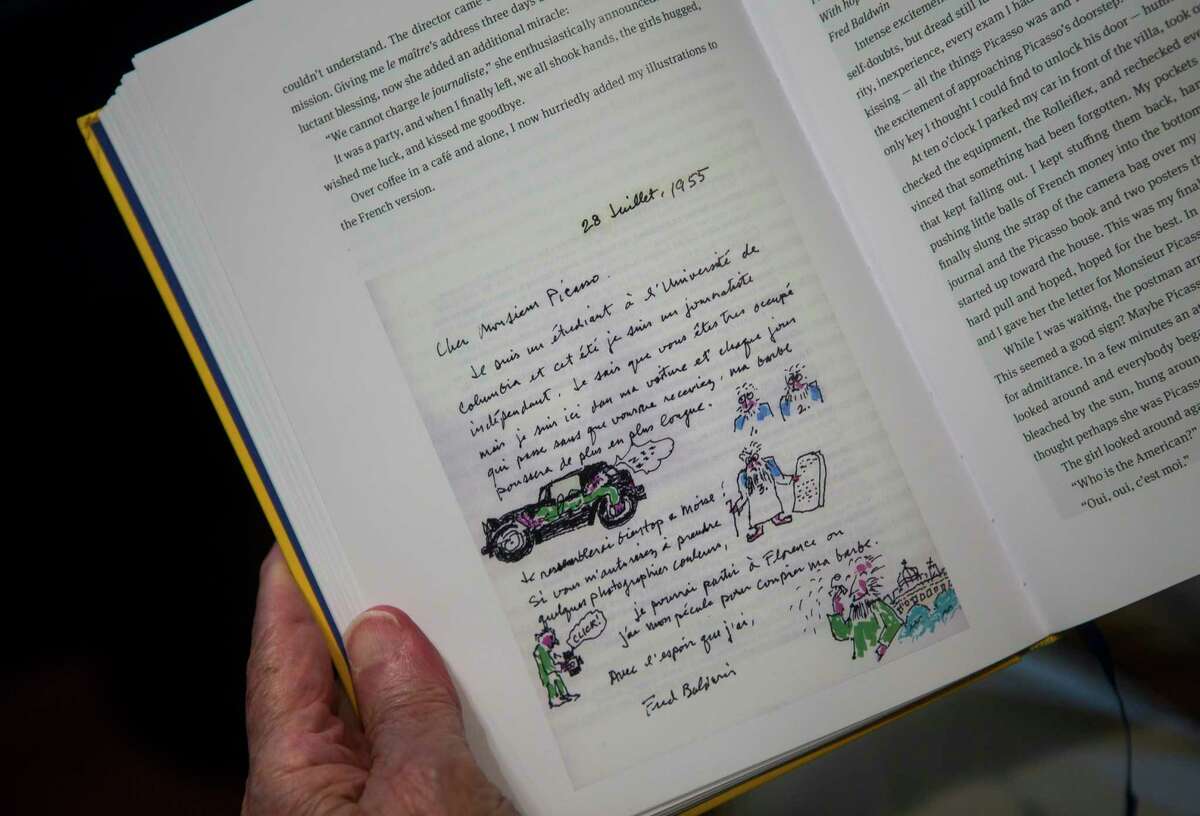 Fred Baldwin holds open a page in his new memoir that shows a hand-illustrated note he wrote to Pablo Picasso in 1955, at his home near the Menil Collection in Houston, Tuesday, June 25, 2019. Baldwin has written a memoir called “Dear Mr. Picasso: An illustrated love affair with freedom” based on diaries he has written over many decades. One chapter describes how a meeting with the iconic painter Pablo Picasso changed his life; the rest details a fascinating voyage of self-discovery including a worldly and sheltered boyhood, a tour of duty in Korea as a U.S. Marine, and his first adventures in journalism. The book is about 700 pages - and it ends just as FotoFest begins.
