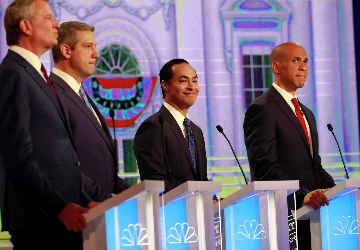 Democratic presidential candidates former Housing Sec. Julian Castro, second from right, smiles, during the Democratic primary debate hosted by NBC News at the Adrienne Arsht Center for the Performing Art, Wednesday, June 26, 2019, in Miami. (AP Photo/Wilfredo Lee)