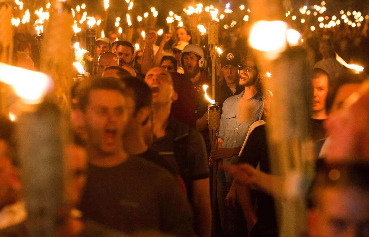 Neo Nazis, Alt-Right, and White Supremacists taking part in a march through the University of Virginia campus the night before the deadly 'Unite the Right' rally in Charlottesville, VA. The growth of online radicalism requires the private sector to come together for solutions.