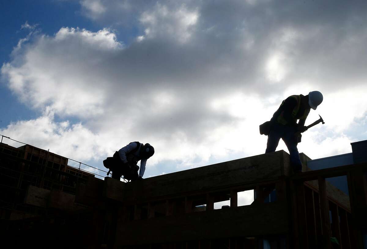 Construction workers build condominiums at the Ice House development by City Ventures in Oakland, Calif. on Thursday, June 27, 2019.