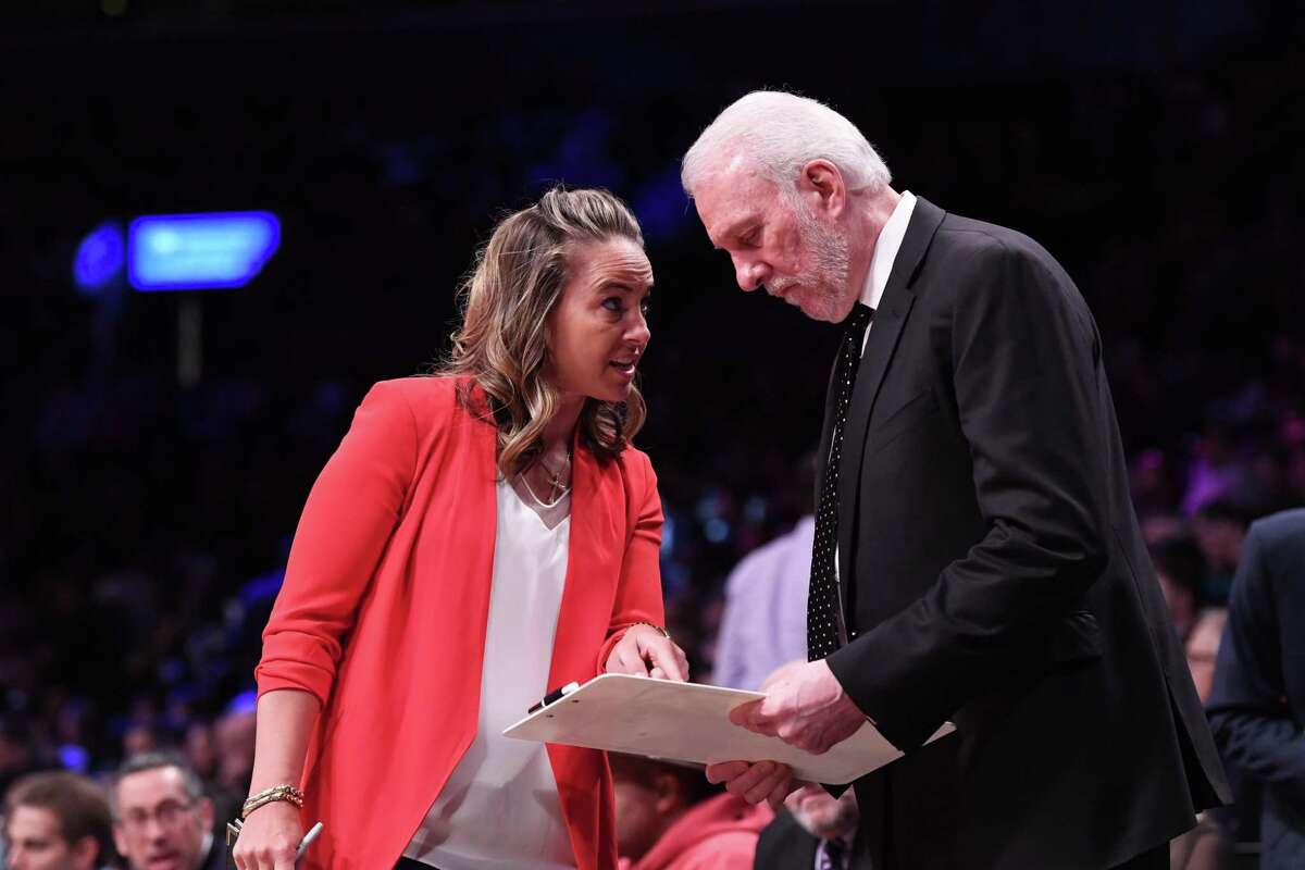 Assistant coach Becky Hammon with Gregg Popovich of the San Antonio Spurs during the game against the Brooklyn Nets at Barclays Center on February 25, 2019 in the Brooklyn borough of New York City.