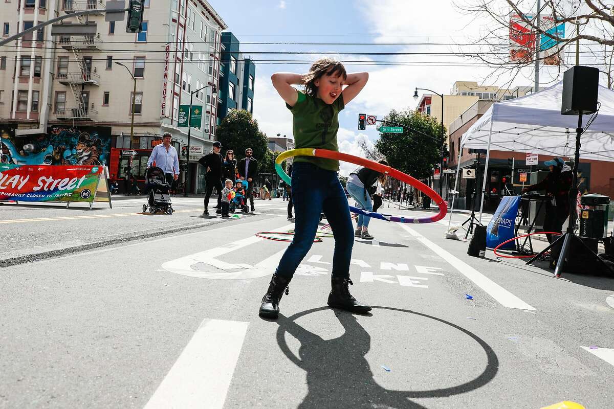 Delaney Rosenbloom, 8, (center) of Reno, Nevada hoola hooped during Sunday Streets where Valencia Street was car-free and open for the public to enjoy in San Francisco, California, on Sunday, March 10, 2019.