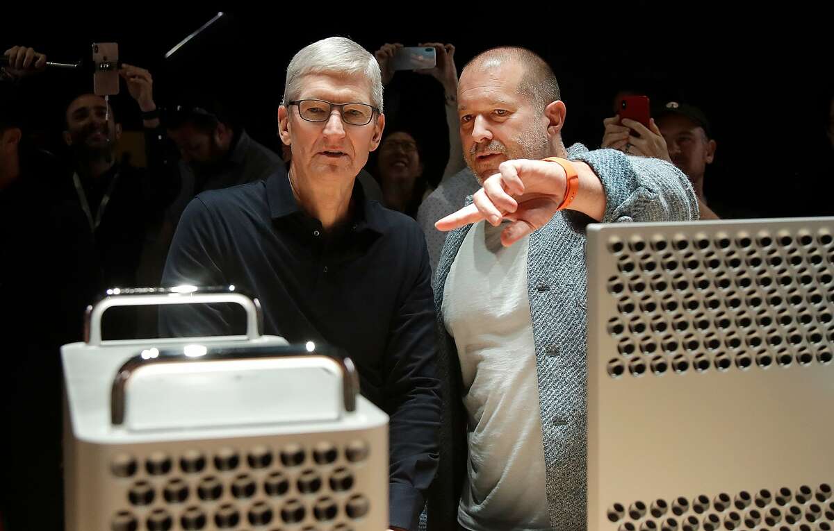 FILE - In this Monday, June 3, 2019 file photo, Apple CEO Tim Cook, left, and chief design officer Jonathan Ive look at the Mac Pro in the display room at the Apple Worldwide Developers Conference in San Jose, Calif. On Thursday, June 27, 2019, Apple said that Ive, chief design officer, will be leaving after more than two decades at the company to start his own firm. (AP Photo/Jeff Chiu)