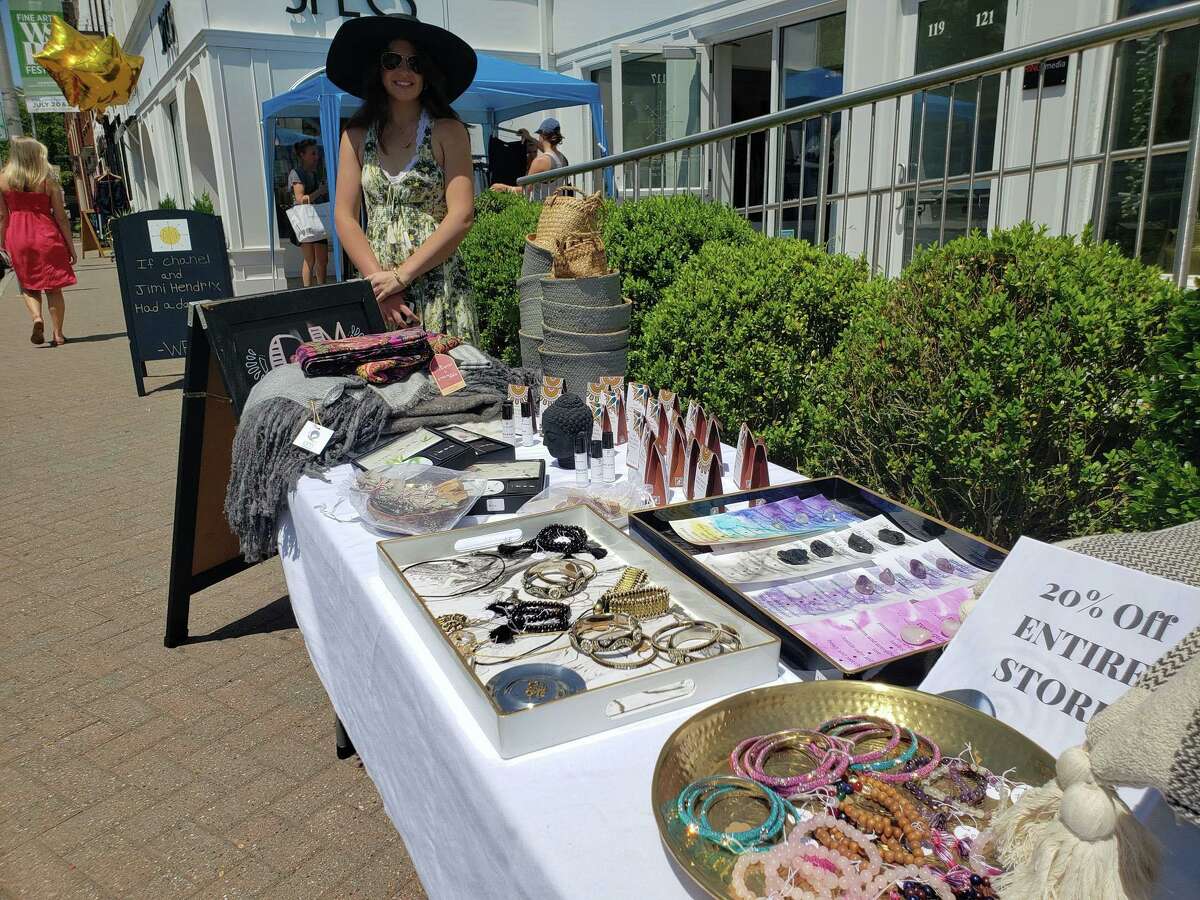 Om in the Home employee Emily Callahan watches her table during the annual Westport Sidewalk Sale throughout Main Street, Post Road and areas surrounding downtown on June 28, 2019. Om in the Home moved to its new location on Post Road East two weeks ago.