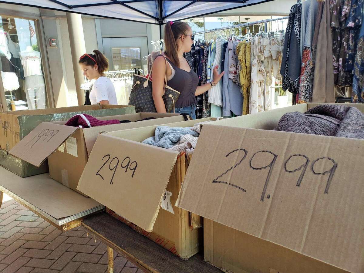 Shoppers check out the clothing deals outside Oddz during the annual Westport Sidewalk Sale throughout Main Street, Post Road and areas surrounding downtown on June 28, 2019.