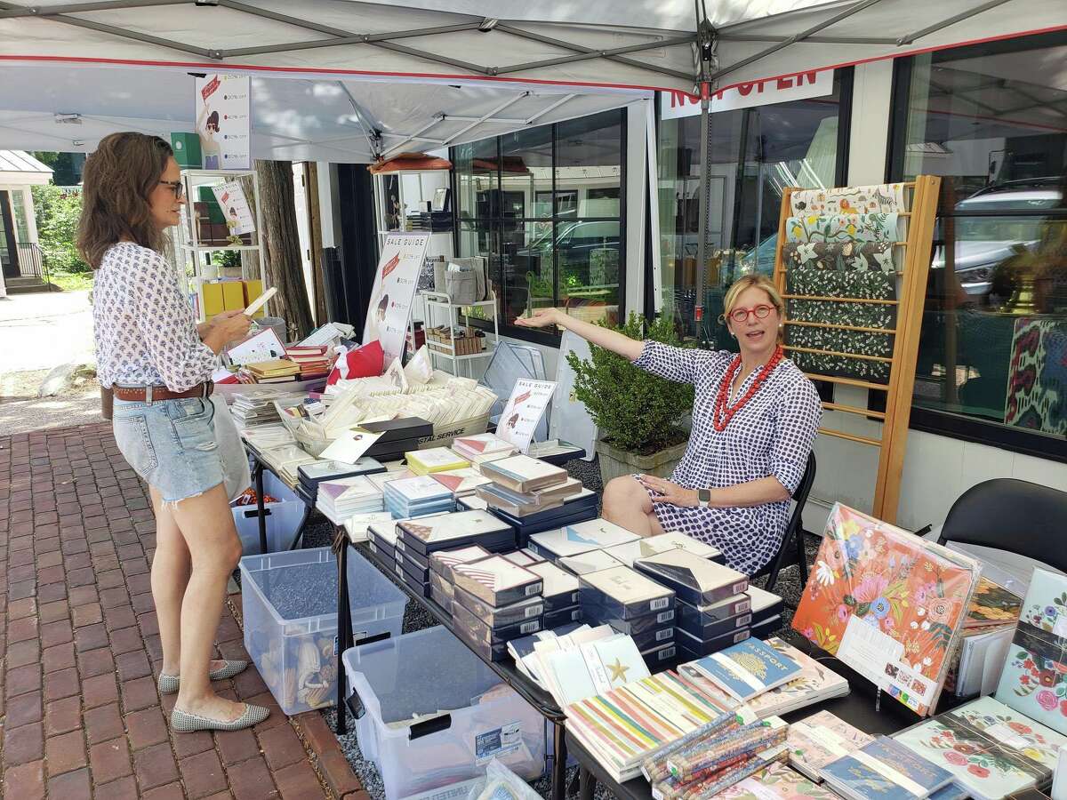 Bespoke Designs owner Shari Lebowitz, right, and customer Roberta Grossberg, of Westport, outside the stationery store during the annual Westport Sidewalk Sale throughout Main Street, Post Road and areas surrounding downtown on June 28, 2019.