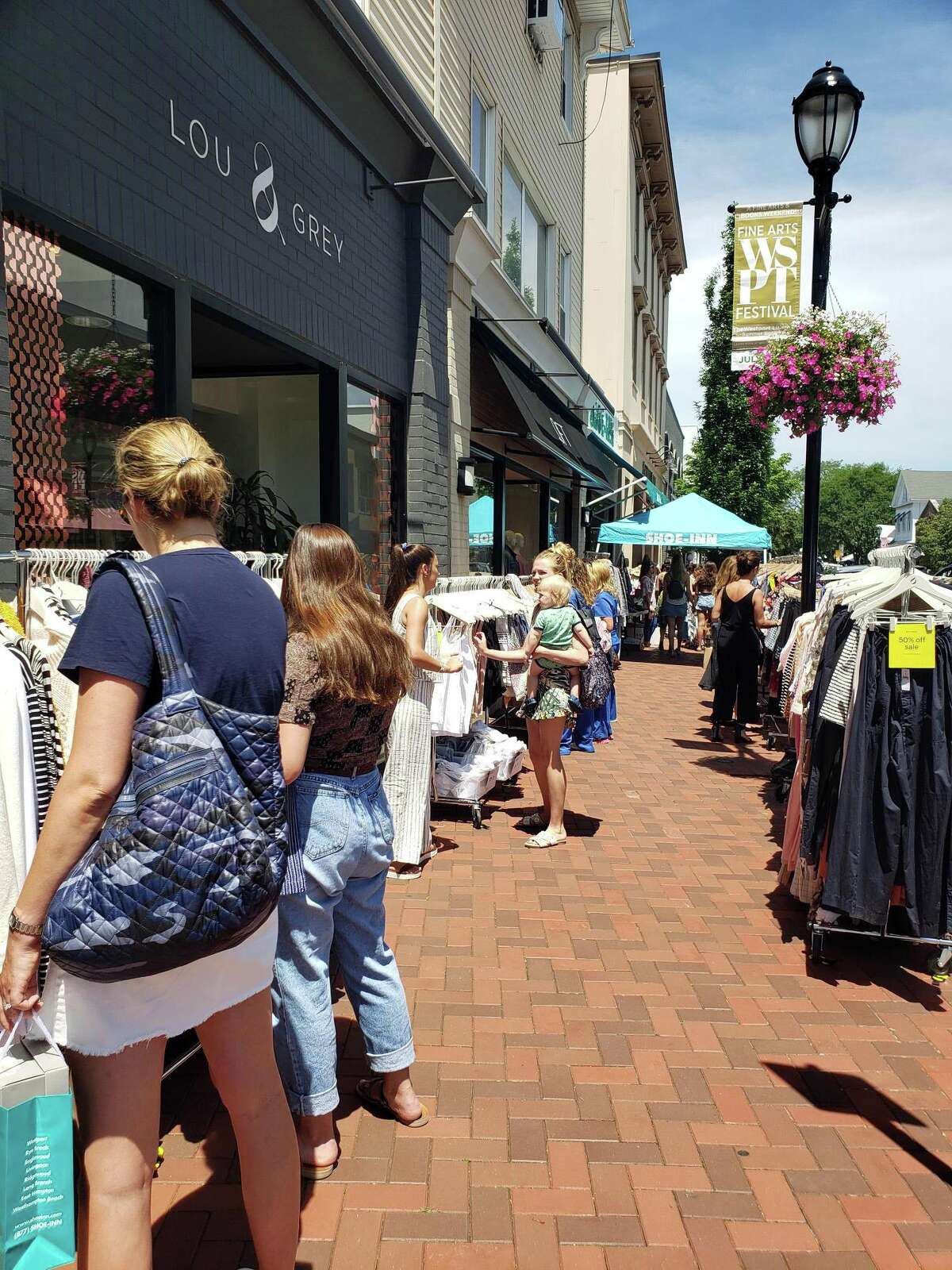 Shoppers peruse during the annual Westport Sidewalk Sale throughout Main Street, Post Road and areas surrounding downtown on June 28, 2019.