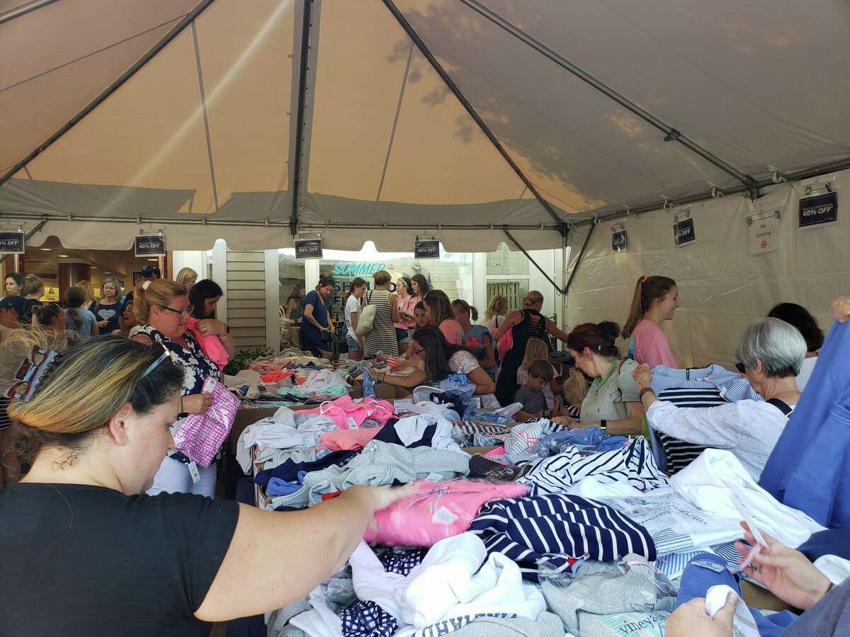 Shoppers peruse marchandise outside Vineyard Vines during the annual Westport Sidewalk Sale throughout Main Street, Post Road and areas surrounding downtown on June 28, 2019.