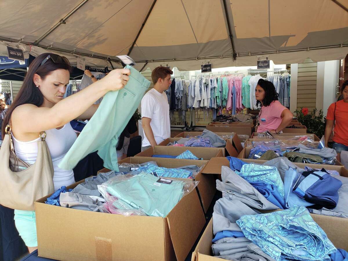 Shoppers peruse boxes at Vineyard Vines during the annual Westport Sidewalk Sale throughout Main Street, Post Road and areas surrounding downtown on June 28, 2019.