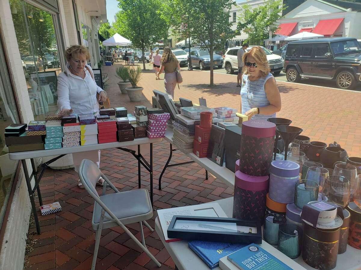 Shoppers peruse items outside Papyrus during the annual Westport Sidewalk Sale throughout Main Street, Post Road and areas surrounding downtown on June 28, 2019.