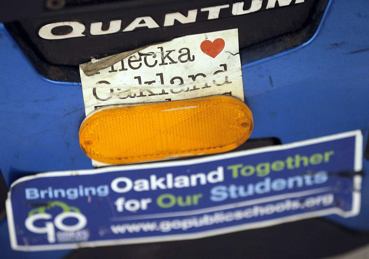 Deborah Wysinger's bumpers stickers on her mobility chair show her appection for Oakland and Oakland School during a meeting at McClymonds High School, in Oakland, Calif., on Tuesday, January 13, 2015. Parents and teachers at McClymonds High School gathered at the school to hear a new plan to turnaround failing schools in the district. Parts of the proposal includes the possibility of contracting out with a charter operator. Five schools are on the list for this tactic, including McClymonds.